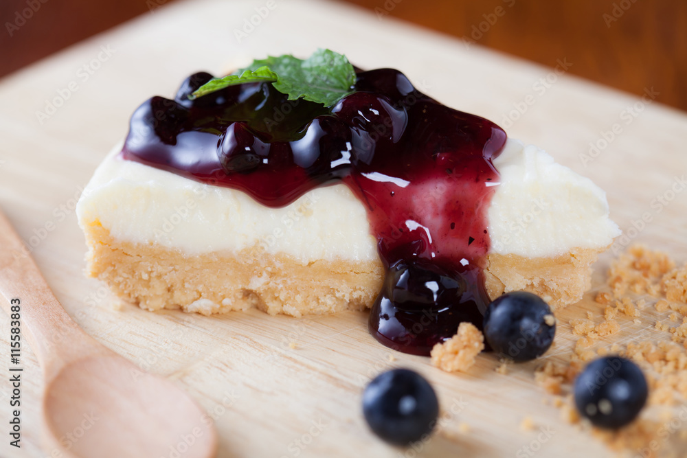 Close up blueberry cake on wooden plate on wood table. Close up blueberry cake on wooden plate on wood table.