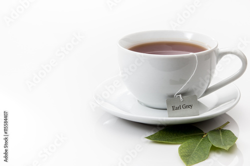 A cup of Earl Grey tea in a white cup and saucer 