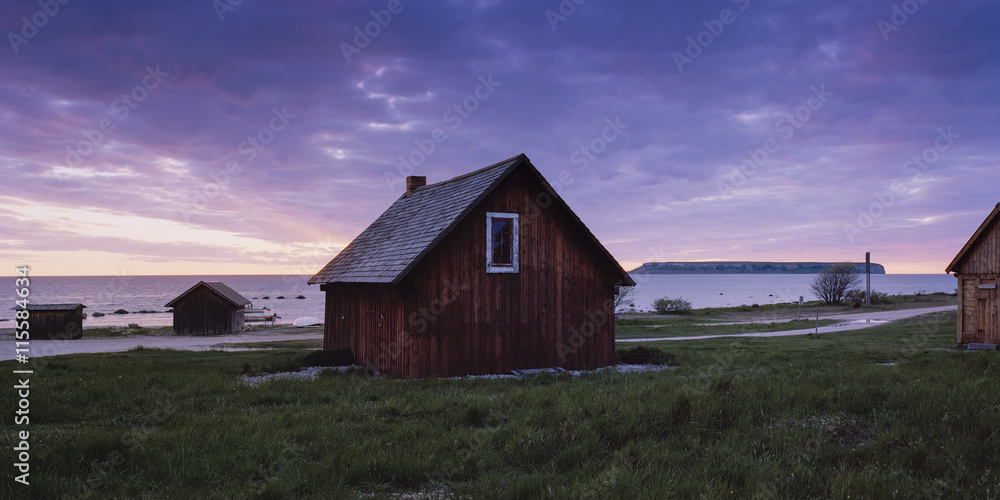 Exterior view of wooden house at dusk Exterior view of wooden house at dusk