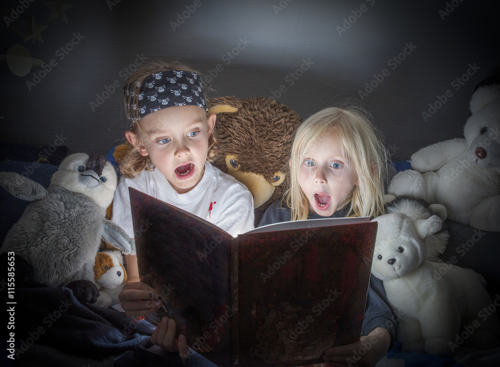 Siblings reading book at home Siblings reading book at home