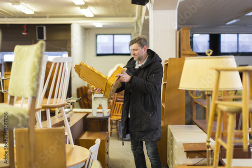 Sweden, Man choosing furniture in store photo