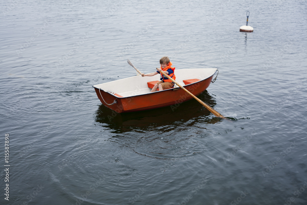 Sweden, Uppland, Runmaro, Barrskar, Boy (6-7) in rowboat Sweden, Uppland, Runmaro, Barrskar, Boy (6-7) in rowboat