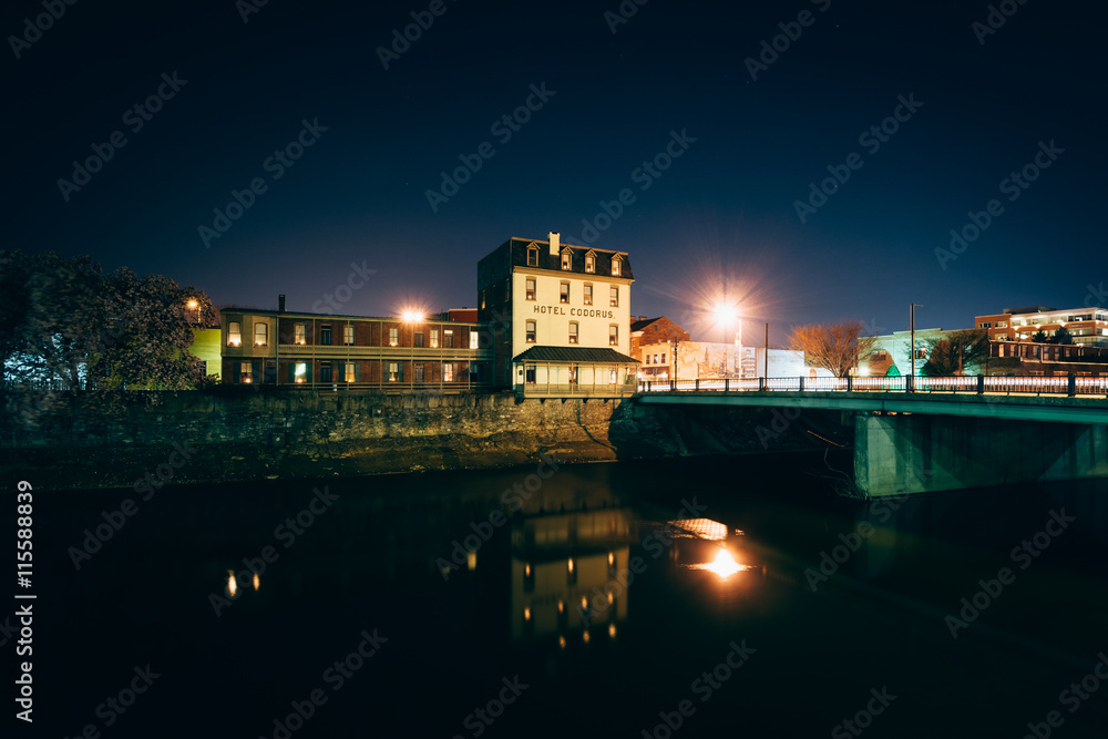 Bridge and buildings along the Codorus Creek at night, in York,