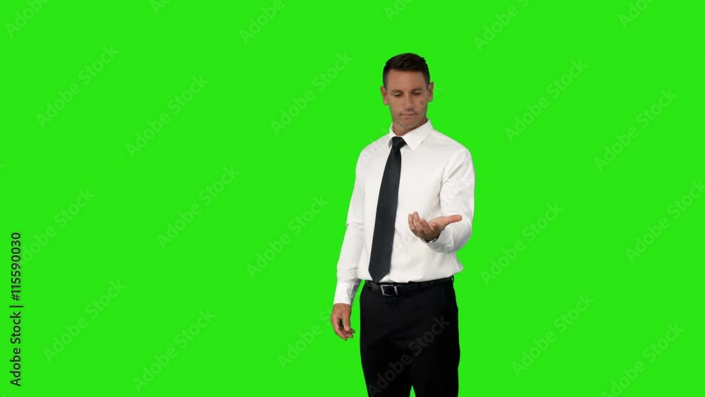 Businessman with his hand out on green screen background Businessman with his hand out on green screen background