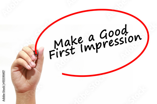 Man Hand writing Make a Good First Impression with marker on transparent wipe board. Business, internet, technology concept.