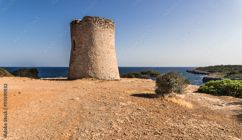 Medieval watchtower Torre de Cala Pi at the coastline of Majorca Spain 