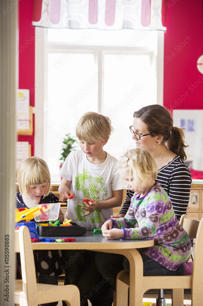 Sweden, Children playing with teacher in kindergarten Sweden, Children playing with teacher in kindergarten