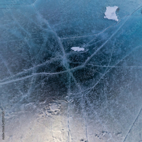 Blue ice of Lake Baikal covered with cracks, cloudy weather at s