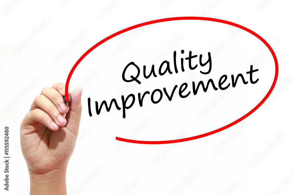 Man Hand writing Quality Improvement with marker on transparent wipe board. Business, internet, technology concept. Man Hand writing Quality Improvement with marker on transparent wipe board. Business, internet, technology concept.