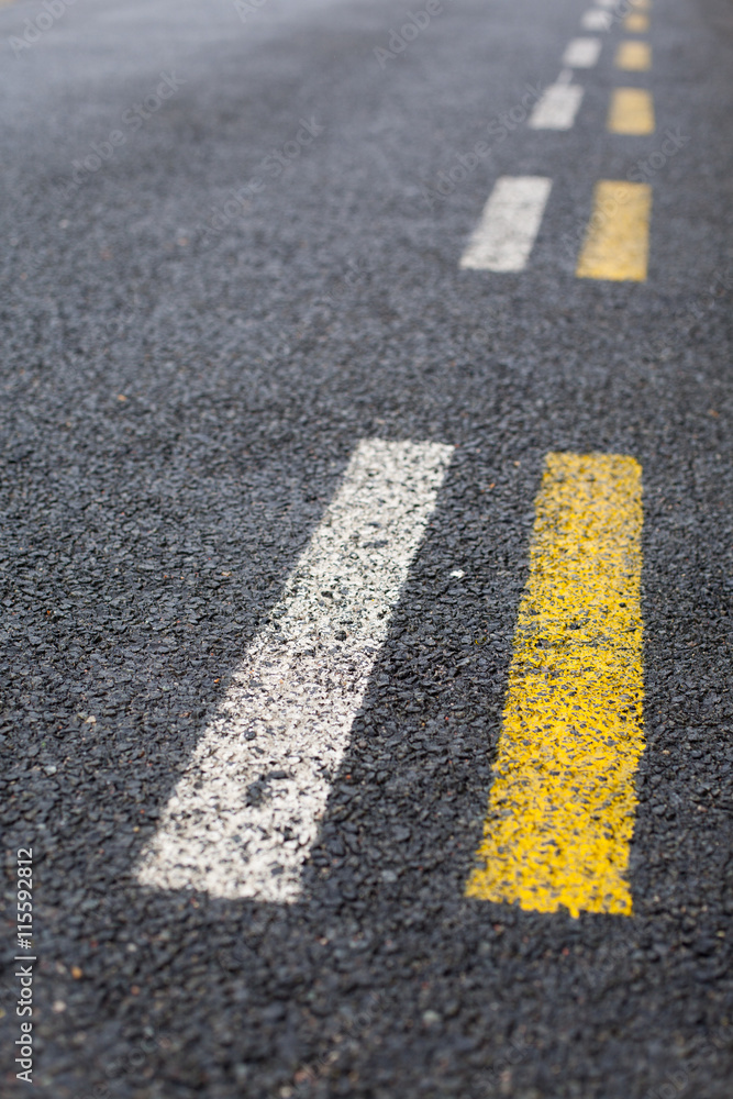 Parallel dashed road lines in white and yellow StockFoto Adobe Stock