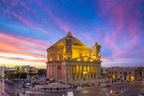 Malta - The famous Mosta Dome with amazing colorful sky at sunset photo