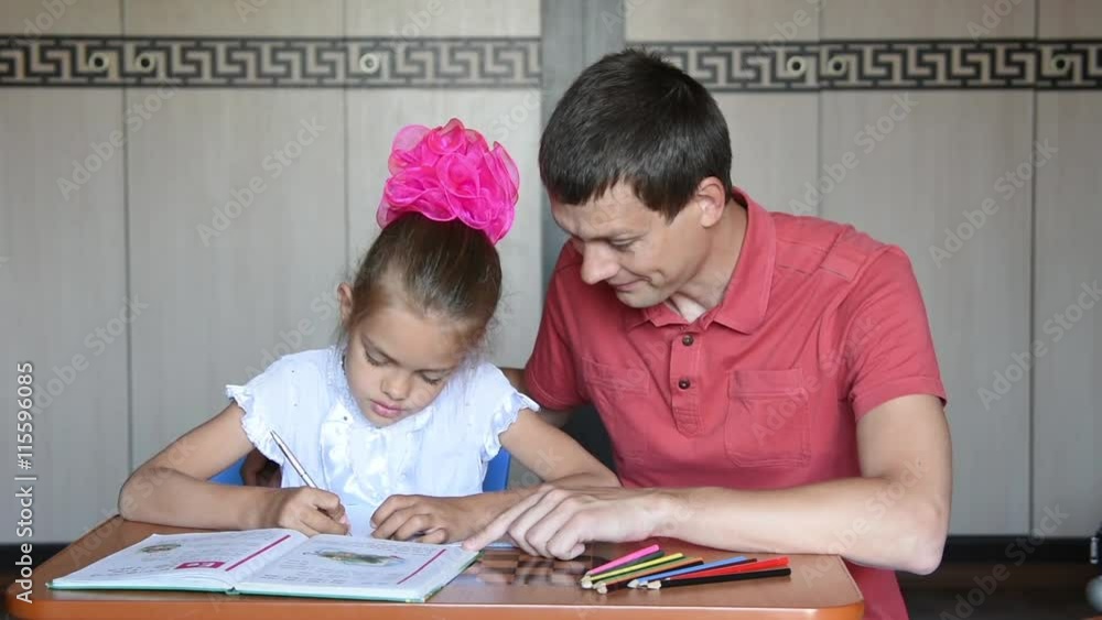 Dad helping homework her daughter grader Dad helping homework her daughter grader