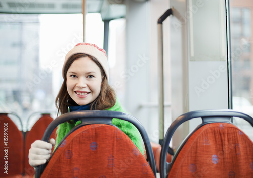 Finland, Helsinki, Young woman behind seatback in tram photo