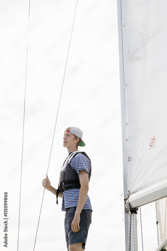 Sweden, View of young man on sailboat Sweden, View of young man on sailboat