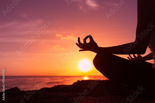 Meditation and a calm mind. closeup of woman's had doing yoga on the beach.