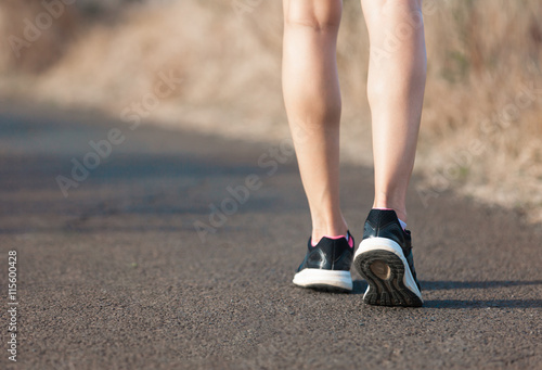 Fit female walking outdoors. Active lifestyle concept. 
