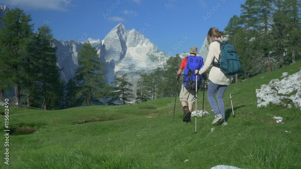 AERIAL: Couple of young hikers in the mountains AERIAL: Couple of young hikers in the mountains