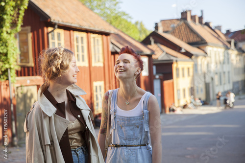 Female friends standing on street photo