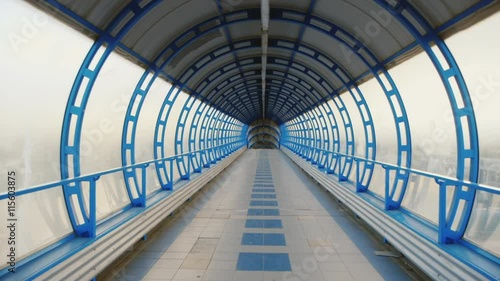 Camera flying through a glass tunnel. The transition between the terminals of the airport or train station. POV video photo