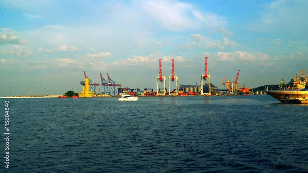 We see cranes seaport passing the port We see cranes seaport passing the port