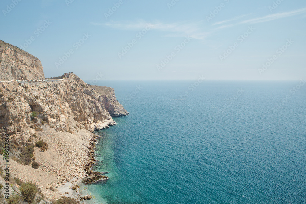Scenic view of rocky coastline by sea Scenic view of rocky coastline by sea