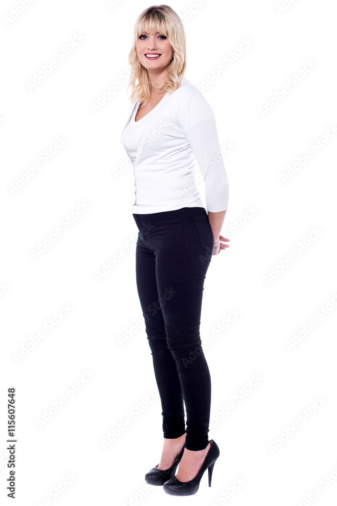 Businesswoman standing with her arms behind her back Businesswoman standing with her arms behind her back