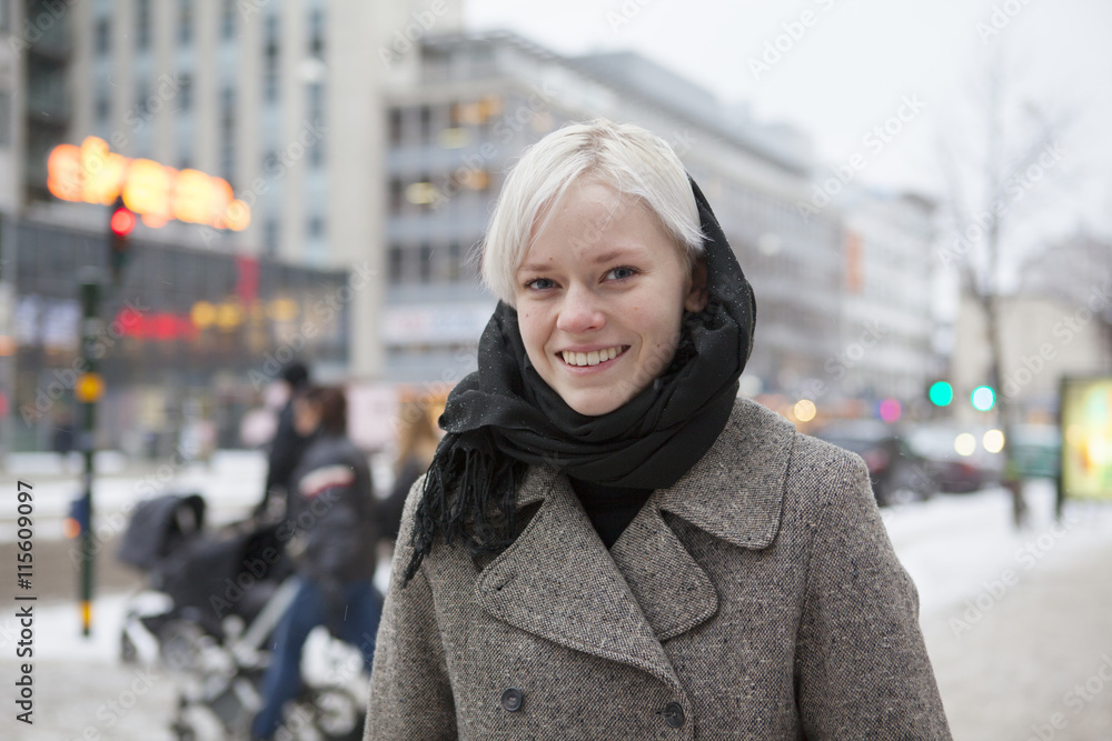 Smiling young woman standing on street Smiling young woman standing on street