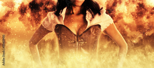 Sexy woman in a bustier engulfed in flames photo