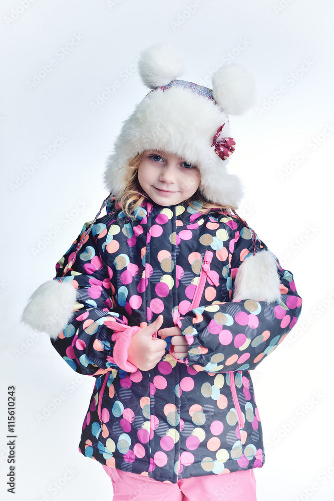 Cute little funny child in colorful winter clothes having fun with snow, outdoors during snowfall. Active outdoors leisure with children in winter. Kid with hat, hand gloves with stripes. Cute little funny child in colorful winter clothes having fun with snow, outdoors during snowfall. Active outdoors leisure with children in winter. Kid with hat, hand gloves with stripes.