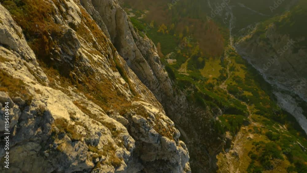 AERIAL: Huge rocky wall in the mountains AERIAL: Huge rocky wall in the mountains