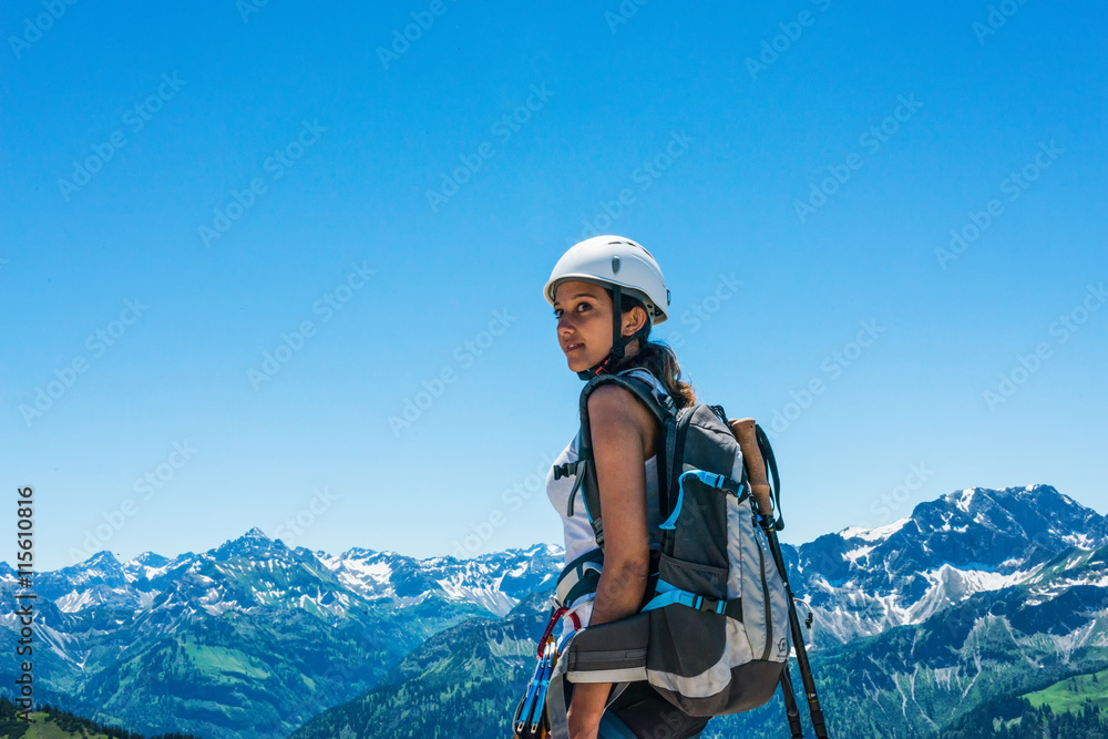 Side view on female hiker facing mountains