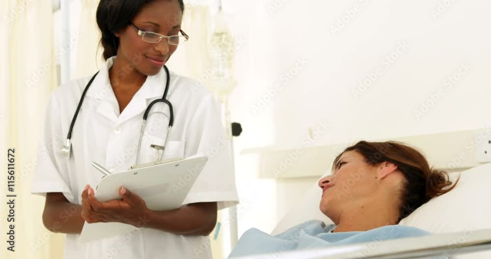 Smiling nurse checking on her patient Smiling nurse checking on her patient