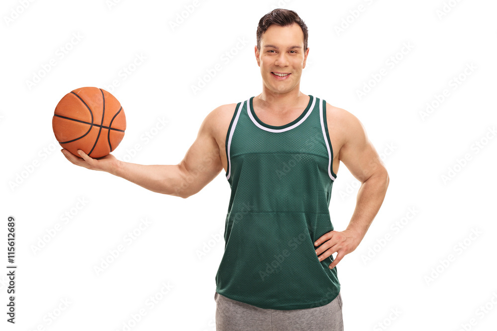 Joyful young man holding a basketball