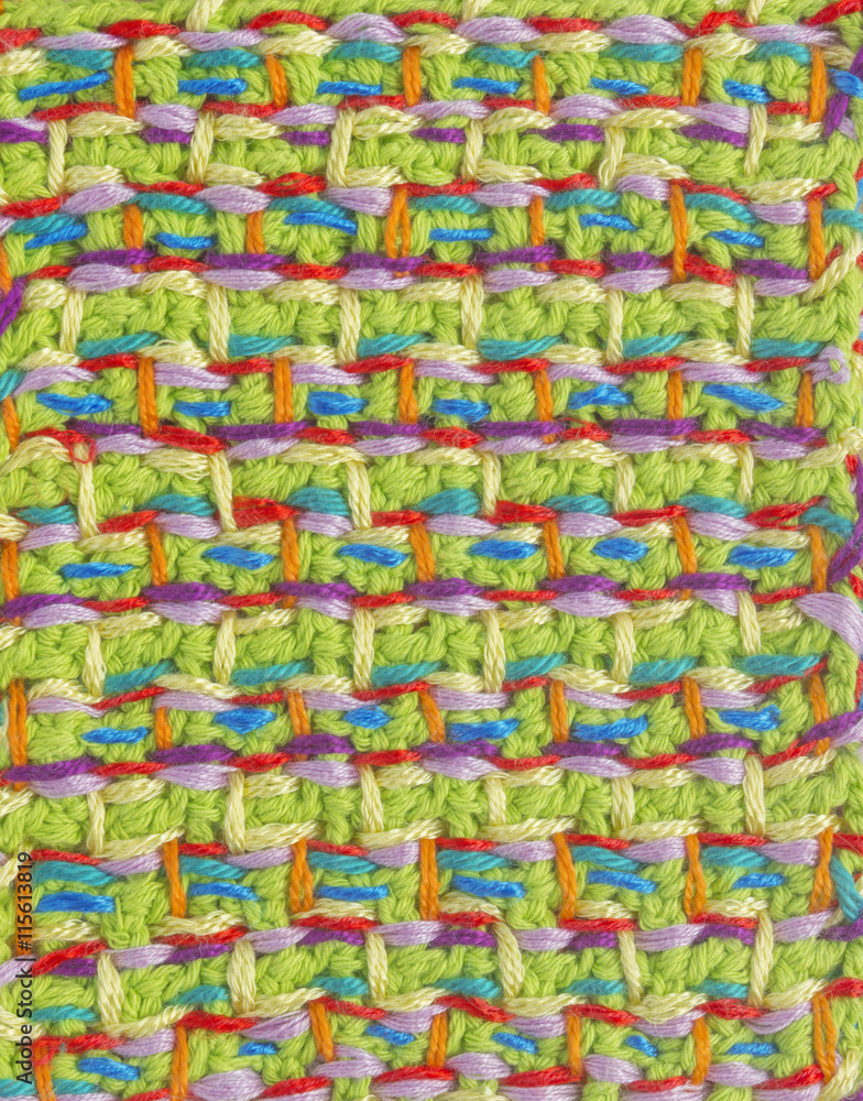 Fototapeta premium Handmade crochet pattern, knitting, sewing. Homemade stitch colorful backdrop, embroidery with flower, lace. Background for sketchbook, notebook. Place for text