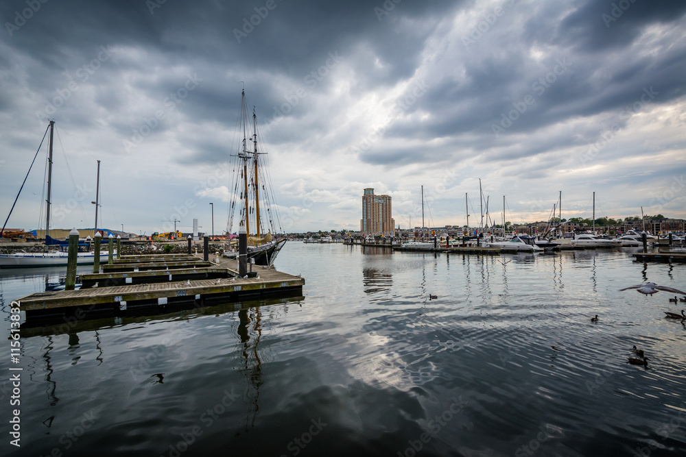 Storm clouds over docks and boats in Harbor East, Baltimore, Mar