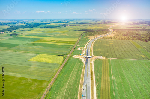 Sunset above new road construction site aerial view