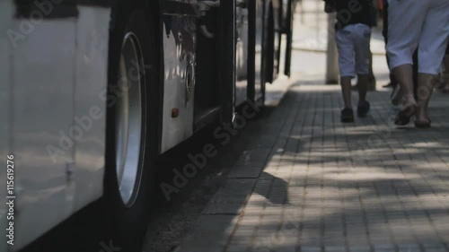 Tramway and bus station focused on pedestrians feet.