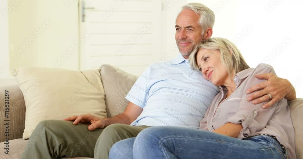 Couple relaxing together on the couch Couple relaxing together on the couch
