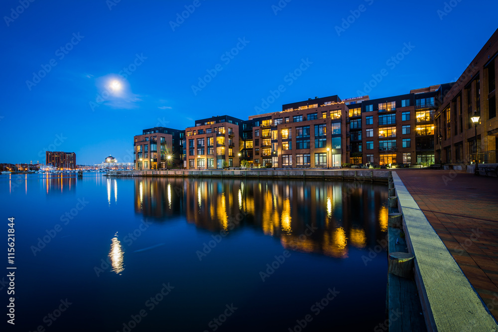 The full moon over a waterfront apartment building in Fells Poin