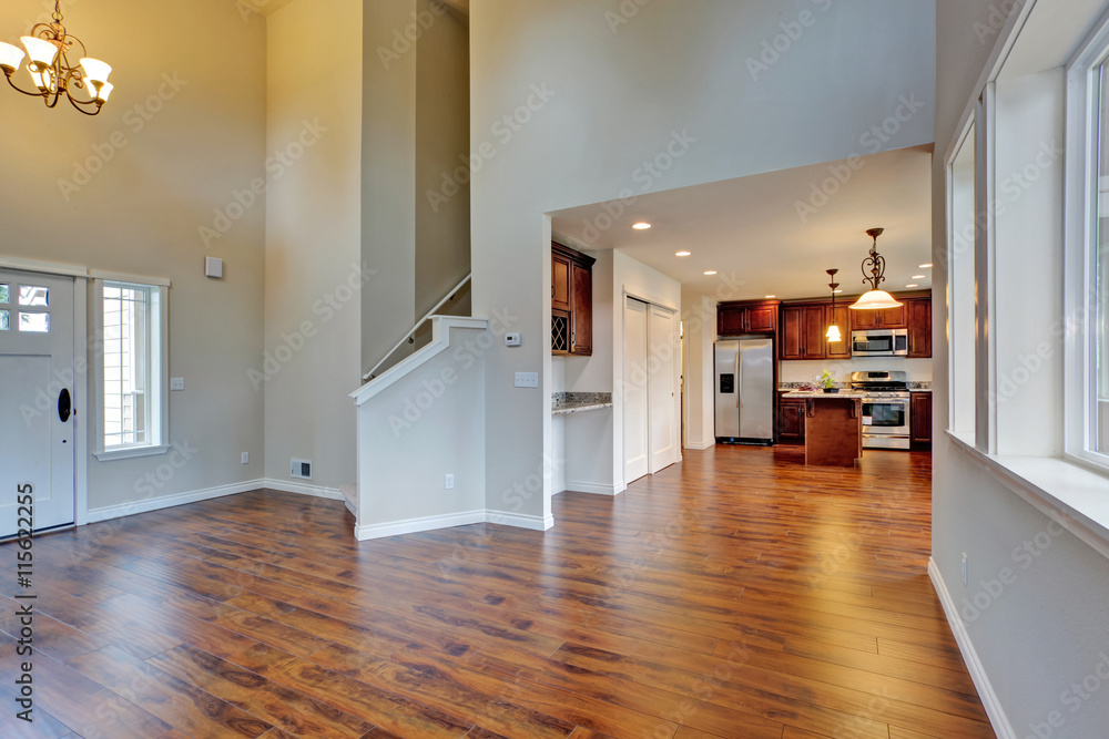 Spacious living room with high vaulted ceiling connected to kitchen Spacious living room with high vaulted ceiling connected to kitchen