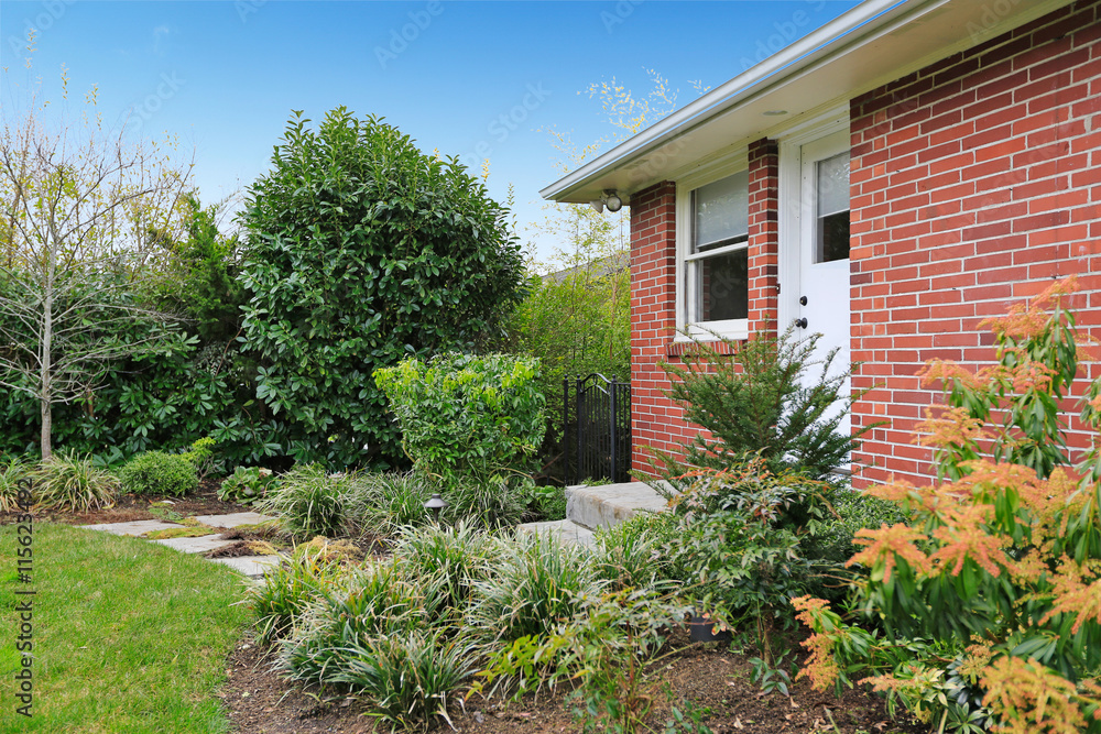 Fenced backyard. View of lawn and flower beds Fenced backyard. View of lawn and flower beds
