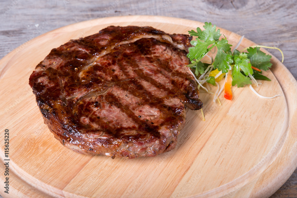 Prepared beef steak on a wooden board Prepared beef steak on a wooden board