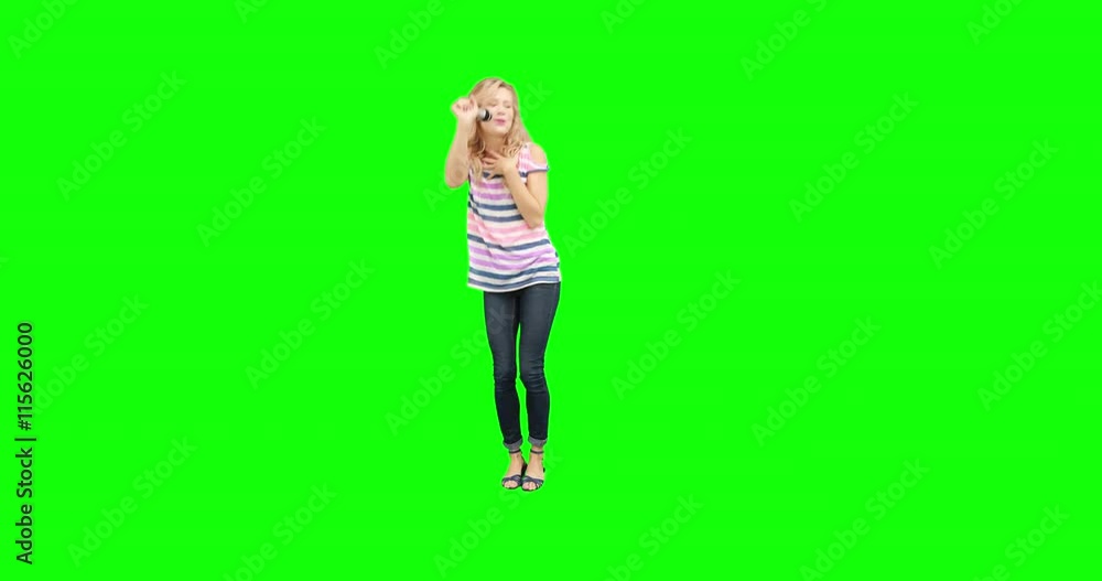 Pretty blonde singing and moving on green screen background