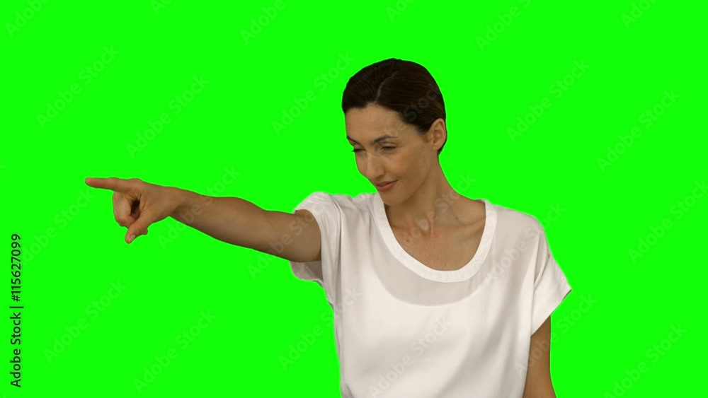 Happy businesswoman pointing on green screen background Happy businesswoman pointing on green screen background