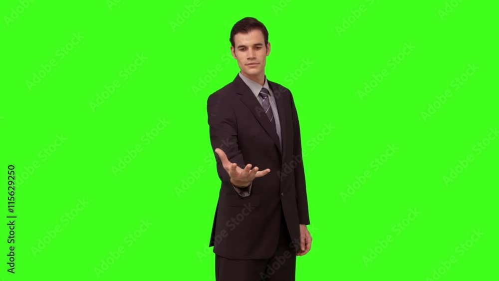 Businessman presenting with his hand on green screen background Businessman presenting with his hand on green screen background
