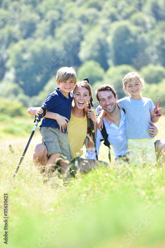 Portrait of happy family on a hiking day in the mountain