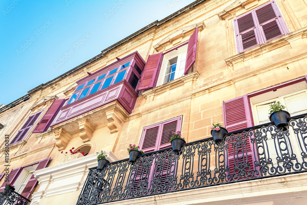 Fototapeta premium Balconies and windows with shutters in Mdina, Malta