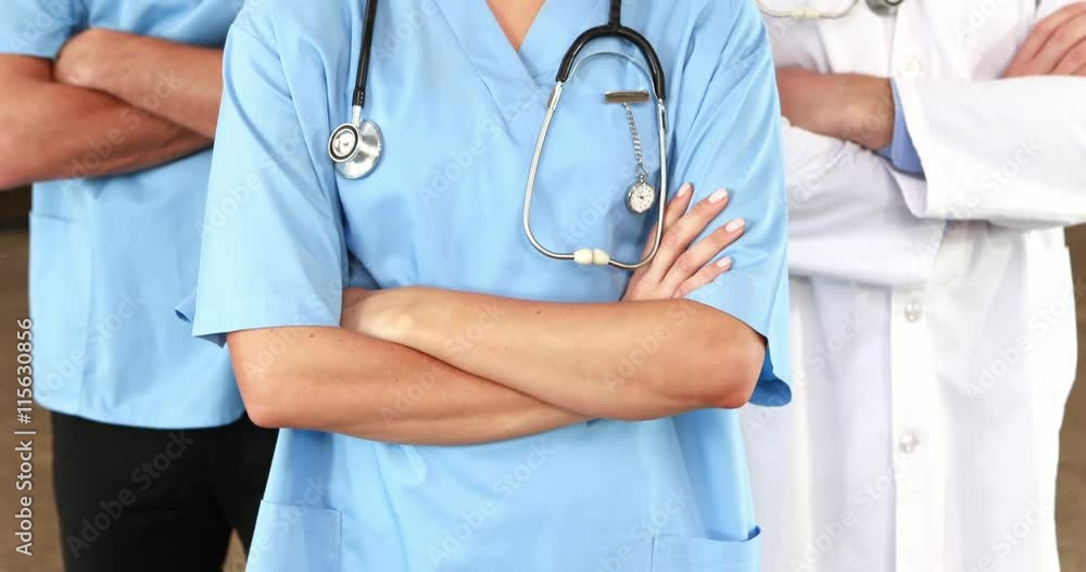 Smiling medical team standing with arms crossed Smiling medical team standing with arms crossed
