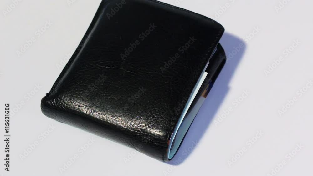 Rotating various of israeli shekel money bills in close black leather wallet - top view. Rotating various of israeli shekel money bills in close black leather wallet - top view.