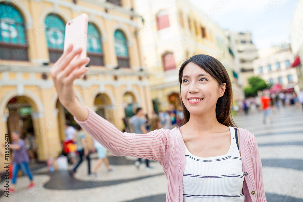 Woman taking selfie in Senado Square of Macao city